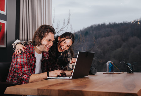 Affectionate couple enjoying time together with a laptop at home