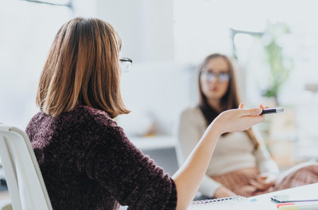 Business colleagues analyzing statistics, discussing financial planning, and strategizing for market expansion.の写真素材