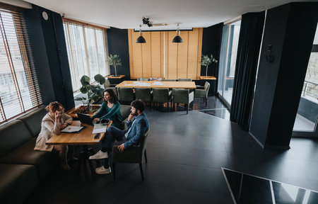 Entrepreneurs analyzing business statistics in a modern office settingの写真素材