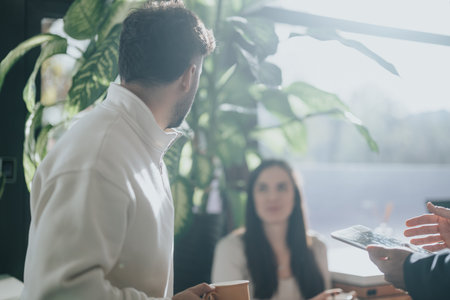 Businesspeople brainstorming ideas and discussing growth strategy in corporate office.