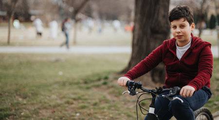 Young boy enjoying a bike ride in the park on a relaxed weekendの写真素材