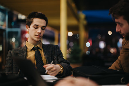 Business entrepreneurs engaged in a strategic meeting at a cafeの写真素材