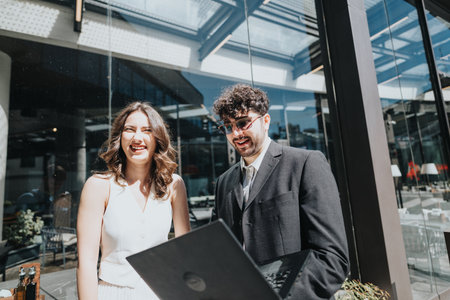 Business professionals laughing together in a sunny city settingの写真素材