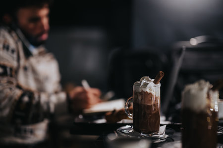 Cozy winter setting with hot chocolate and sweets on a table.