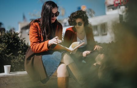 Business colleagues discussing work in an informal outdoor settingの写真素材
