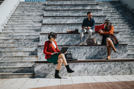 Business professionals in an outdoor meeting on sunny steps