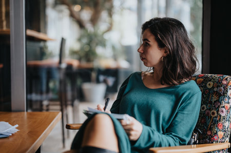 Business entrepreneur at work in a cafe setting, focused and committed