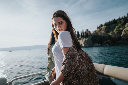 Joyful friends enjoying weekend boat trip on a serene lakeの写真素材