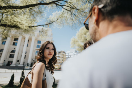 Stylish business partners discuss ideas in a sunny urban settingの写真素材
