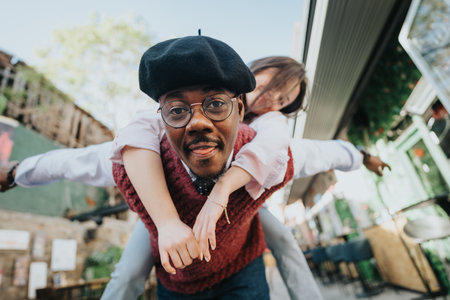 Multiracial friends joyfully piggybacking outdoors on a sunny weekend