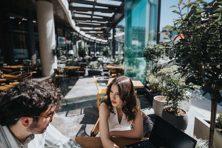 Multigenerational entrepreneurs collaborating at a coffee bar with laptopの写真素材