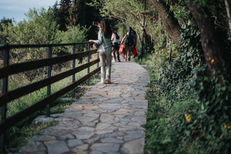 Joyful girl capturing happiness with smart phone in a nature parkの写真素材