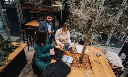 Entrepreneurial team discusses strategies in an urban coffee shop setting