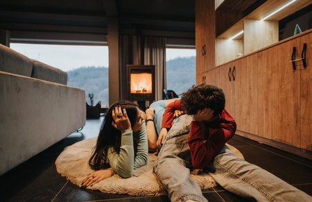Friends relax time in a cozy home with a warm fireplace in the background.の写真素材