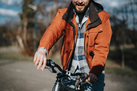 Casual hipster man enjoying free time with bicycle in parkの写真素材
