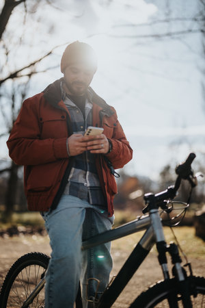 Hipster man enjoying free time with a bicycle in the parkの写真素材
