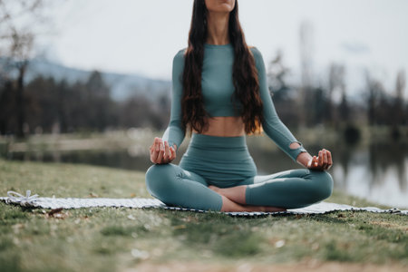 Young woman practicing yoga in a peaceful park setting