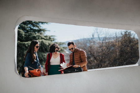 Business colleagues in outdoor meeting discussing project in urban environmentの写真素材