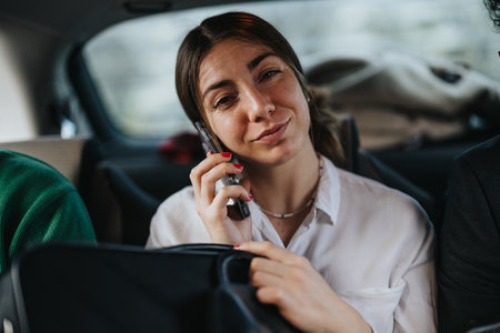 Businesswoman on a phone call while commuting in a car