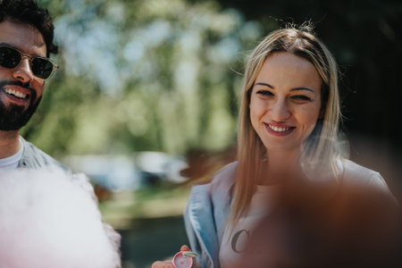 Multiracial friends sharing joyful moments in a sunny urban parkの写真素材