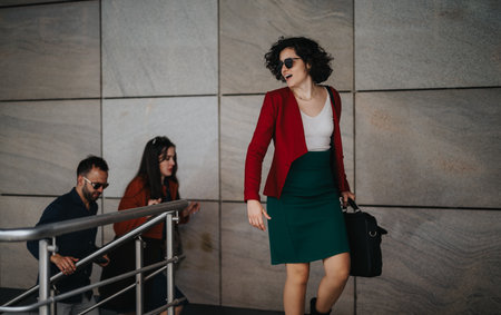 Confident business partners walking in a modern urban settingの写真素材