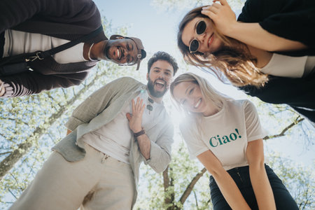 Group of happy friends enjoying a sunny day at an urban park, showing joy and freedomの写真素材