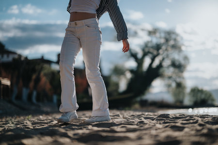 Relaxed person enjoying a tranquil moment on a sandy beach during a vacation journeyの写真素材