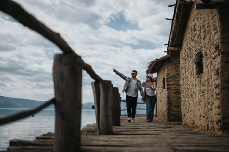 Joyful couple on vacation exploring rustic waterfront together