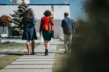 Business colleagues walking to an outdoor meeting on a sunny dayの写真素材