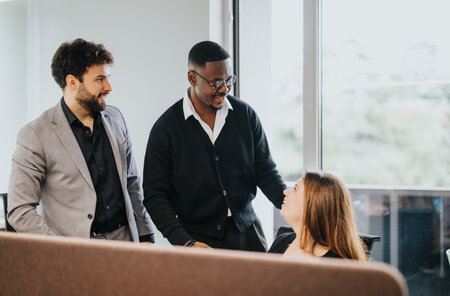 Diverse office team engaged in a lively discussion in a bright workspace