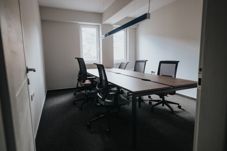 Modern office conference room with natural light and ergonomic chairsの写真素材