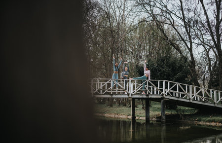 Female athletes exercising outdoors in a peaceful park settingの写真素材