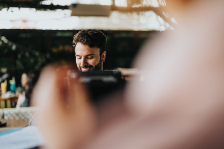 Young businessman smiling while working on his laptop outdoors