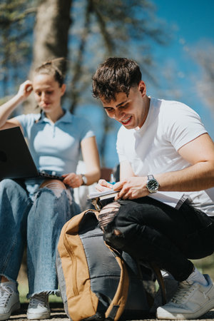 College students studying together in a sunny park, sharing ideas and doing homework