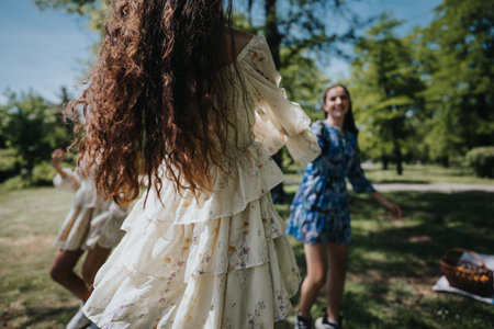 Joyful young women enjoying a sunny spring day in the park, expressing freedom and happinessの写真素材