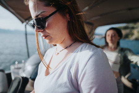 Friends enjoying a relaxing boat trip on a serene lake in spring
