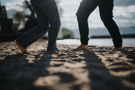 Joyful couple dancing on the beach during a scenic vacation sunsetの写真素材