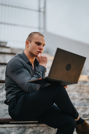 Young man involved in a creative outdoor business meeting with a laptop, discussing a new project