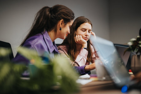 Young female professionals engaged in a collaborative business meeting at modern office