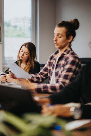 Business colleagues engaged in a project discussion at a modern officeの写真素材
