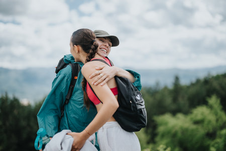 Two women hiking in nature, sharing a warm embrace and smiling joyfully