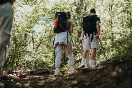 Hikers walking along a forest trail enjoying nature and adventure outdoorsの写真素材
