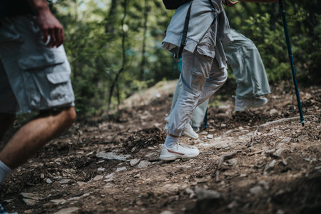 Hikers trekking through the forest on a rocky trail during an outdoor adventureの写真素材