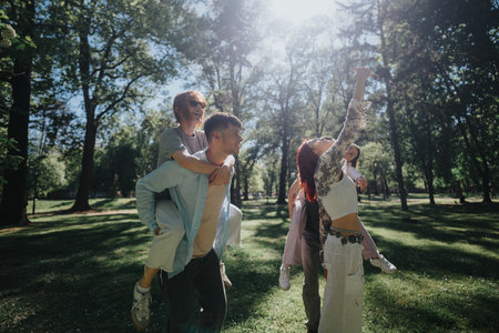 Overjoyed friends enjoying a fun day in a sunlit park, taking selfies togetherの写真素材