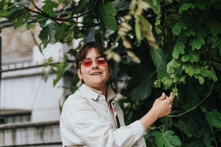 Smiling person with sunglasses enjoying outdoor greenery
