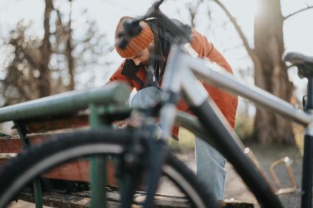 Active man preparing to ride a bicycle in a park setting