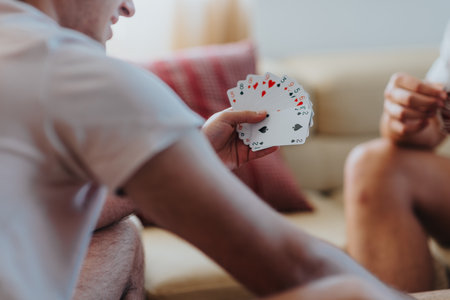 Friends playing cards and enjoying a relaxed afternoon at homeの写真素材