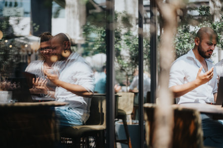 Business workers collaborating on a project in a coffee bar, brainstorming ideas and sharing...