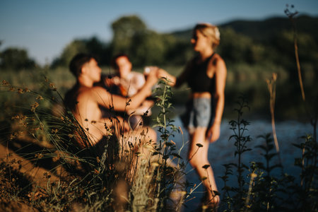 Family enjoying nature by the lake on a sunny summer dayの写真素材