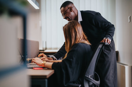 Senior manager mentoring a junior employee at a modern office setup